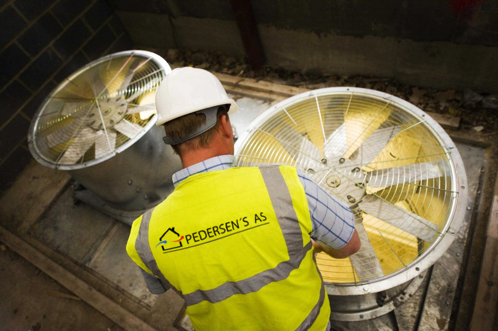 Montør fra Pedersens AS i arbeid med ventilasjonsanlegg.